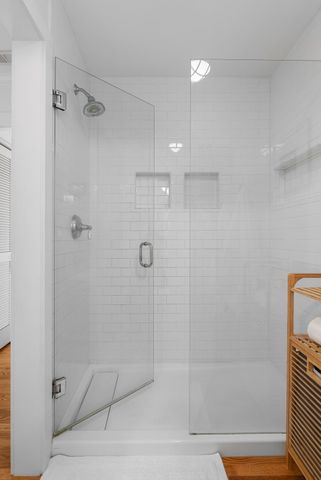 a living room with furniture floor to ceiling window and a flat screen tv