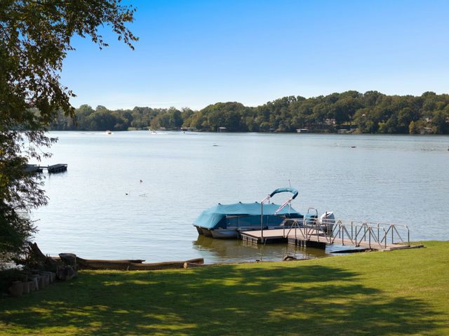 a bathroom with a toilet sink vanity and mirror