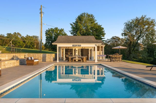 a view of a house with pool and deck