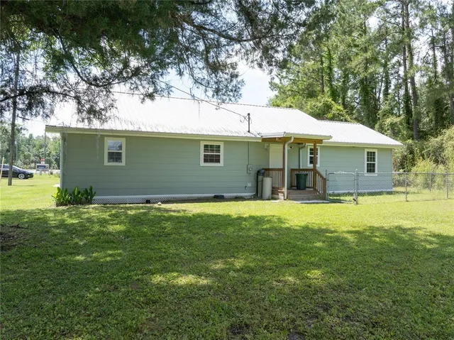 a front view of house with yard and trees