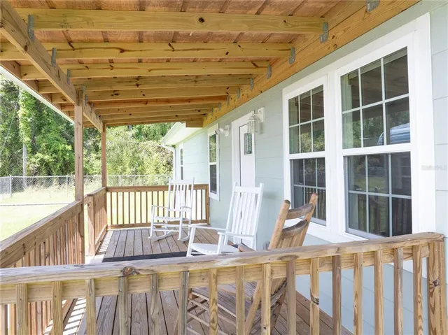 a view of a house with backyard and porch