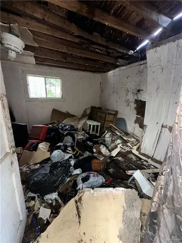 a backyard of a house with lawn chairs and wooden fence