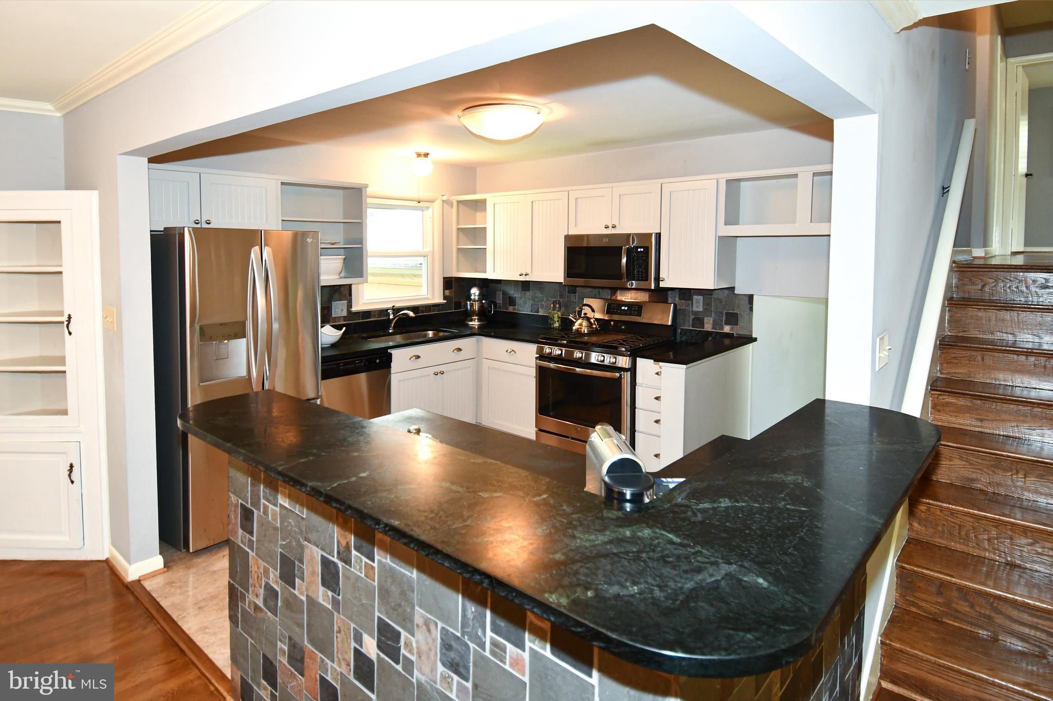 8916 Battery Road Alexandria, VA 22308 - Photo 13 of 53 Breakfast Bar with View of Kitchen Cabinets.
