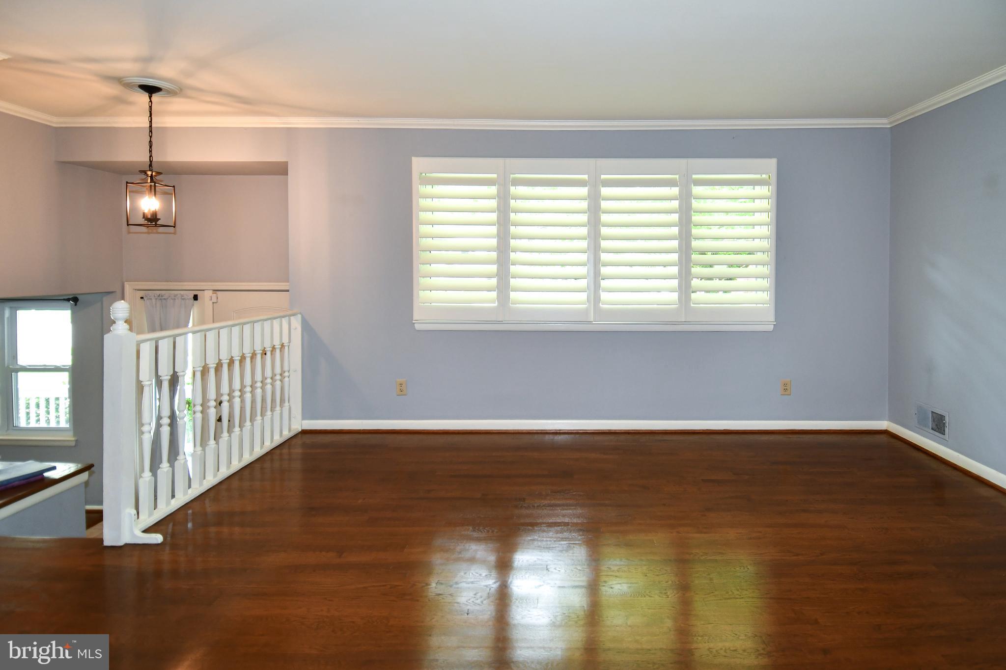 8916 Battery Road Alexandria, VA 22308 - Photo 8 of 53 Living room with wood blinds & beautiful HW Flrs.