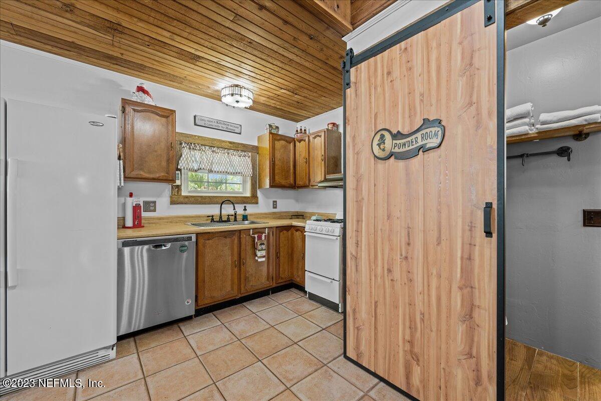 108 Creekside Road Satsuma, FL 32189 - Photo 11 of 40 a kitchen with a sink cabinets and wooden floor