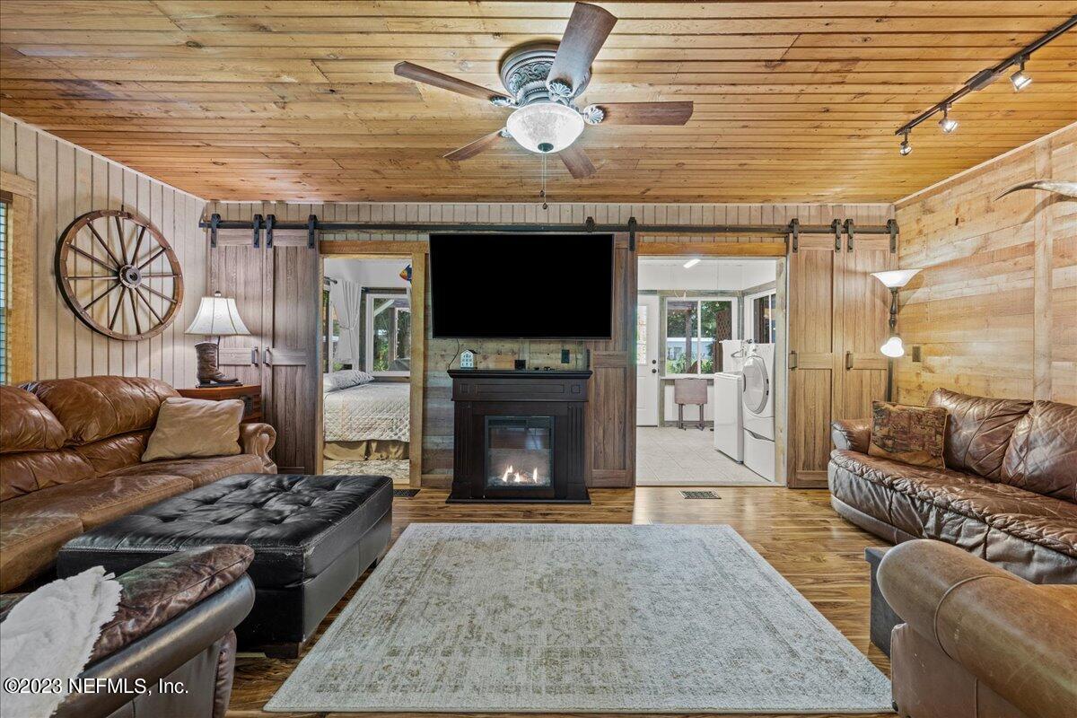 108 Creekside Road Satsuma, FL 32189 - Photo 15 of 40 a living room with furniture a flat screen tv and a fireplace
