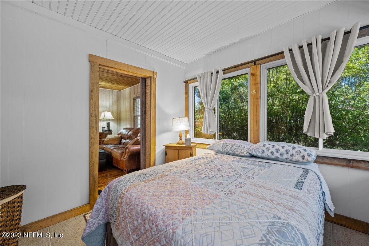 108 Creekside Road Satsuma, FL 32189 - Photo 20 of 40 a bedroom with a bed and large windows