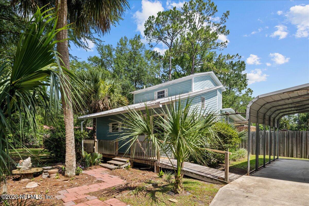 108 Creekside Road Satsuma, FL 32189 - Photo 2 of 40 a view of backyard with wheel chair potted plants and large tree