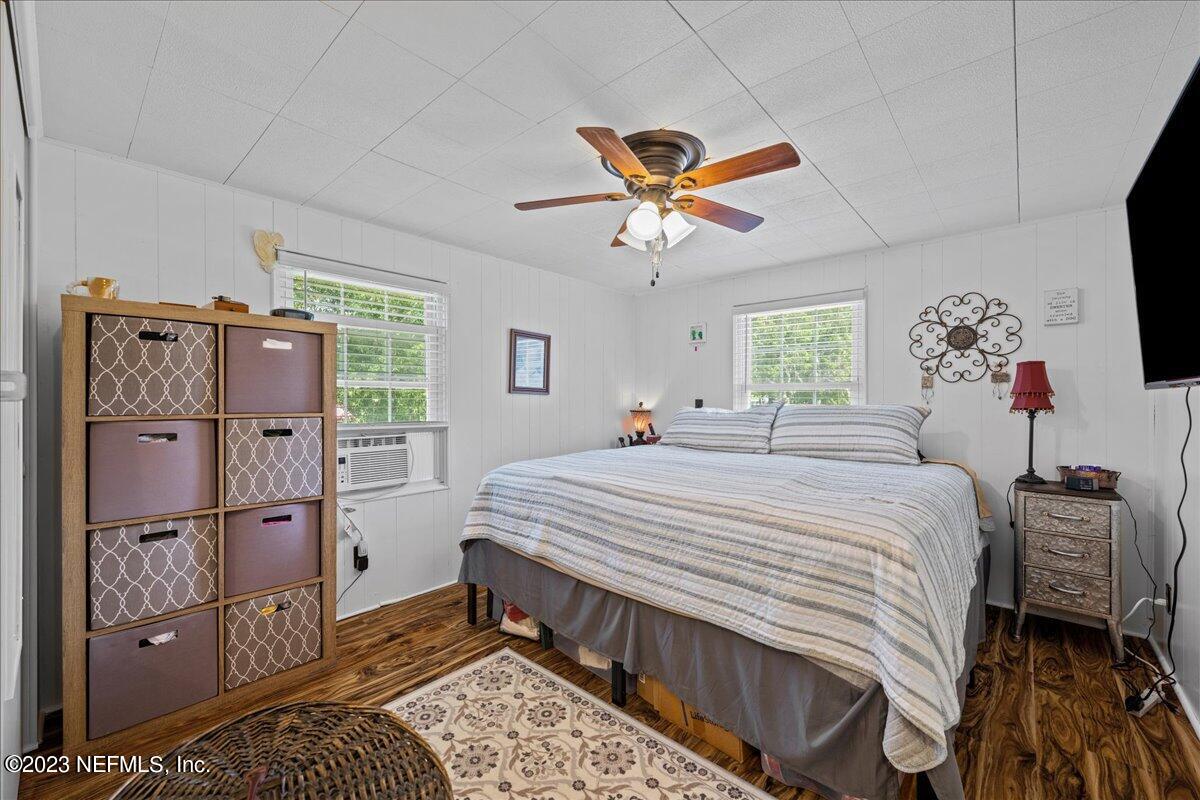 108 Creekside Road Satsuma, FL 32189 - Photo 23 of 40 a bed room with a bed and a chandelier