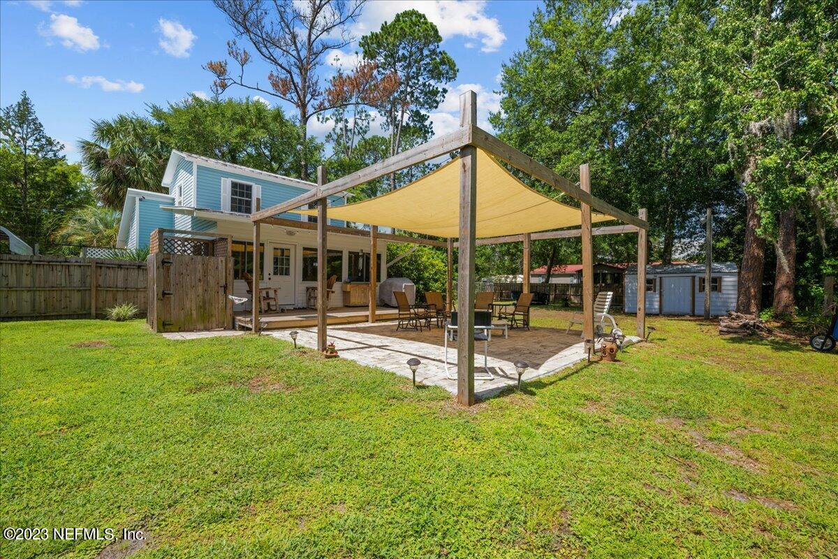 108 Creekside Road Satsuma, FL 32189 - Photo 29 of 40 a view of a house with a backyard and a patio
