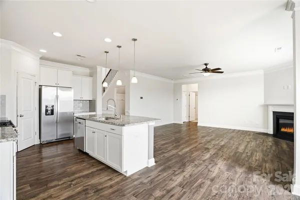 a kitchen with stainless steel appliances granite countertop a stove and a refrigerator