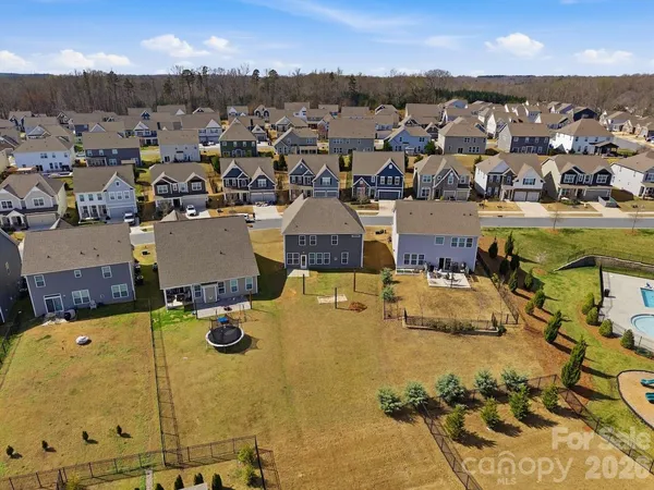 an aerial view of a houses with yard