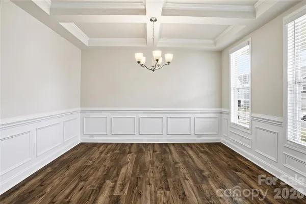 a view of wooden floor and windows in a room