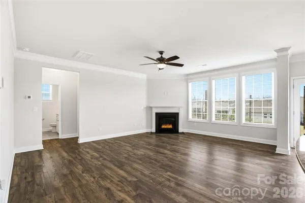a view of an empty room with glass door and a window