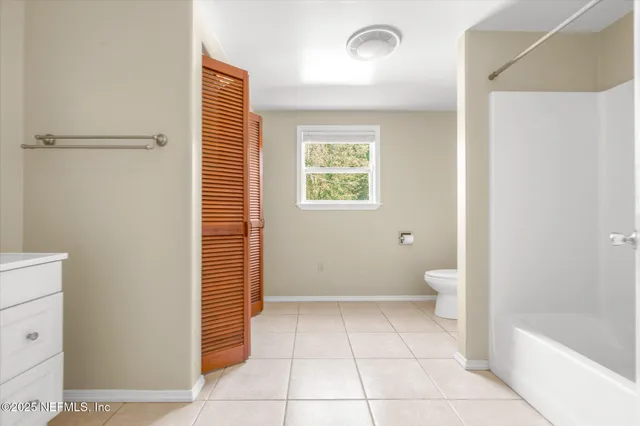 a bathroom with a toilet a sink and bathtub