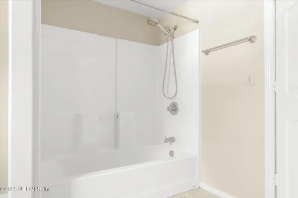 a bathroom with a shower and a bath tub