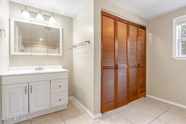 a bathroom with a sink a mirror and a window