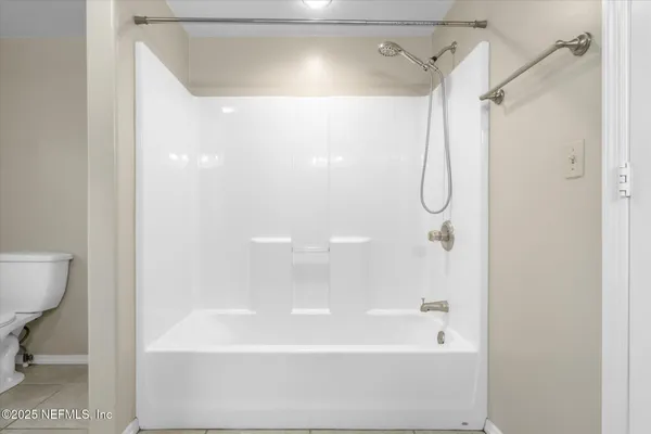 a bathroom with a shower and a bath tub