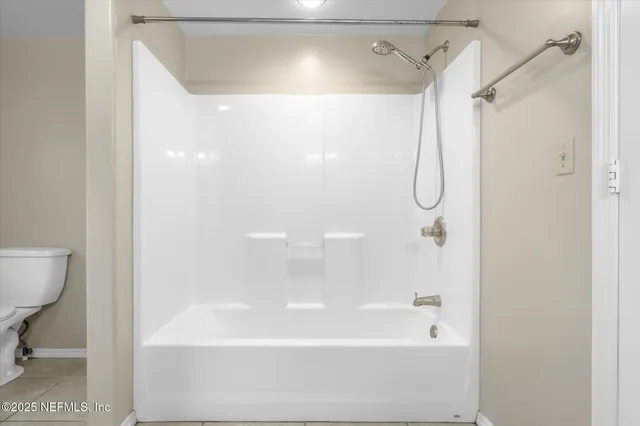 a bathroom with a shower and a bath tub