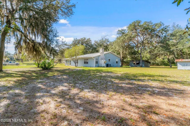 a swimming pool with outdoor seating and yard