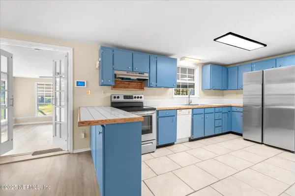 a kitchen with stainless steel appliances a refrigerator and a sink