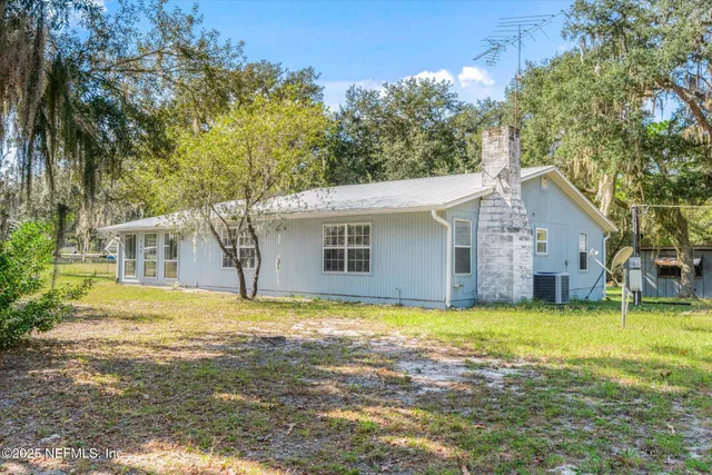 a view of a yard with a house and a tree