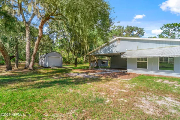 a backyard of a house with lots of green space and deers