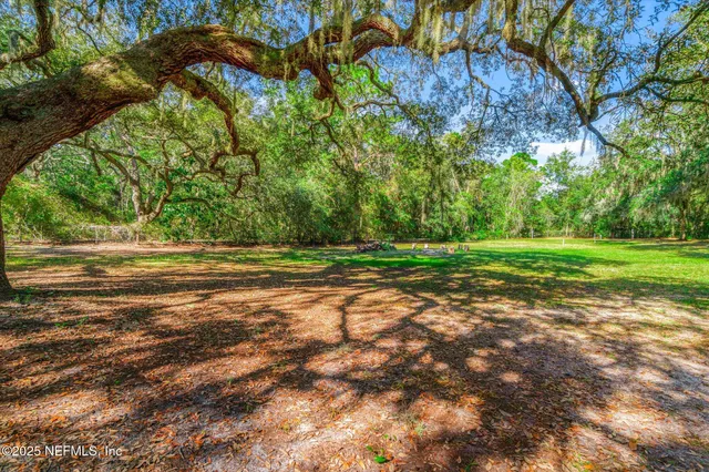 a swimming pool with outdoor seating and yard