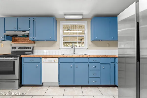 a kitchen with stainless steel appliances granite countertop a sink and cabinets