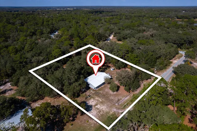 an aerial view of residential house and green space