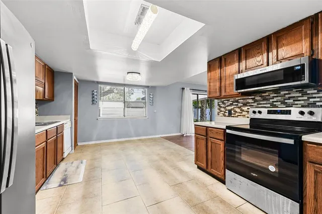 a kitchen with stainless steel appliances granite countertop a stove oven and a refrigerator