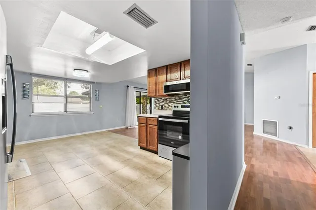 a view of kitchen with stove and refrigerator