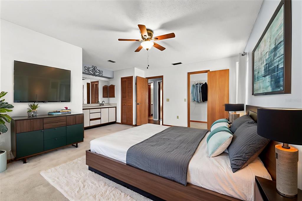 1580 East Normandy Boulevard Deltona, FL 32725 - Photo 17 of 46 a bedroom with a bed and a flat screen tv