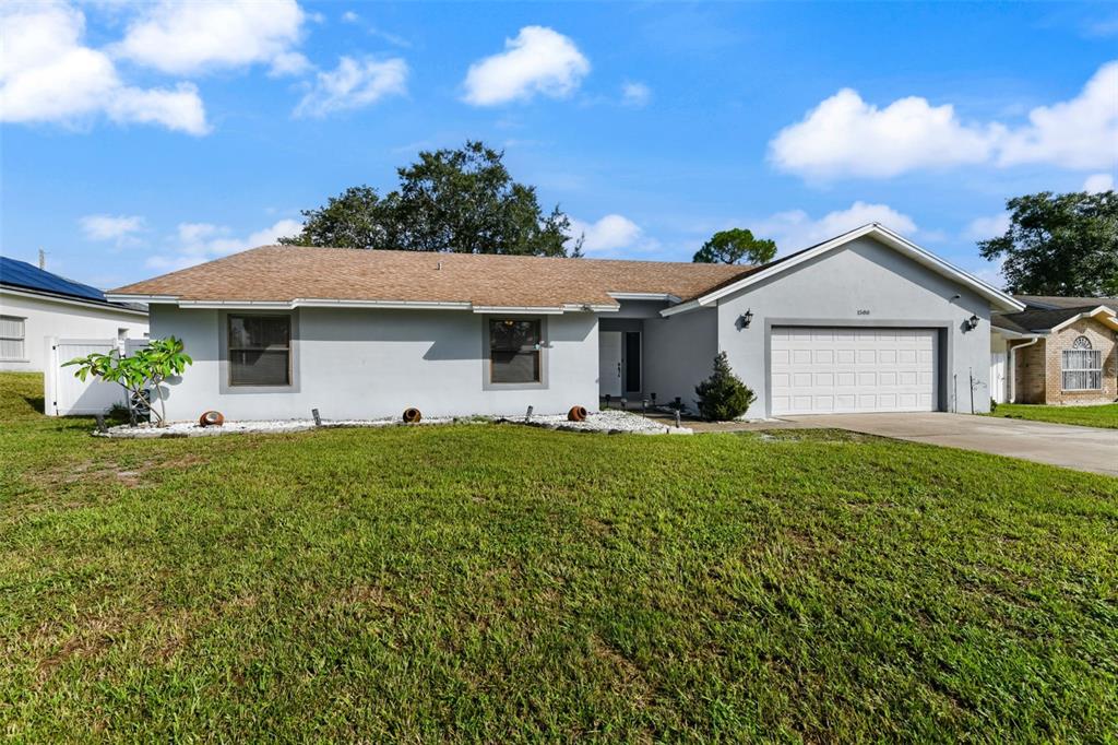 1580 East Normandy Boulevard Deltona, FL 32725 - Photo 2 of 46 a front view of a house with garden