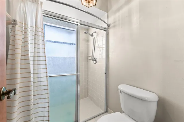 a bathroom with a shower and a toilet