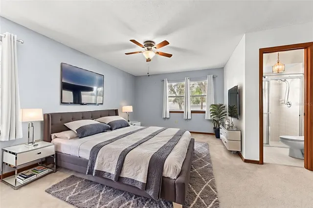 a bedroom with a bed and a chandelier