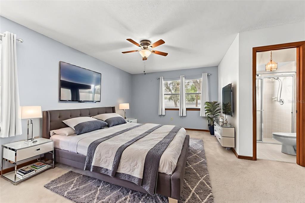 1580 East Normandy Boulevard Deltona, FL 32725 - Photo 22 of 46 a bedroom with a bed and a chandelier