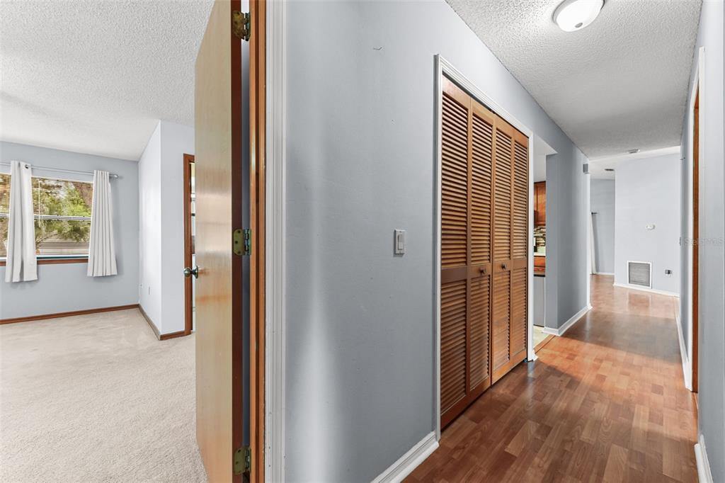 1580 East Normandy Boulevard Deltona, FL 32725 - Photo 23 of 46 a view of a hallway with wooden floor and closet area