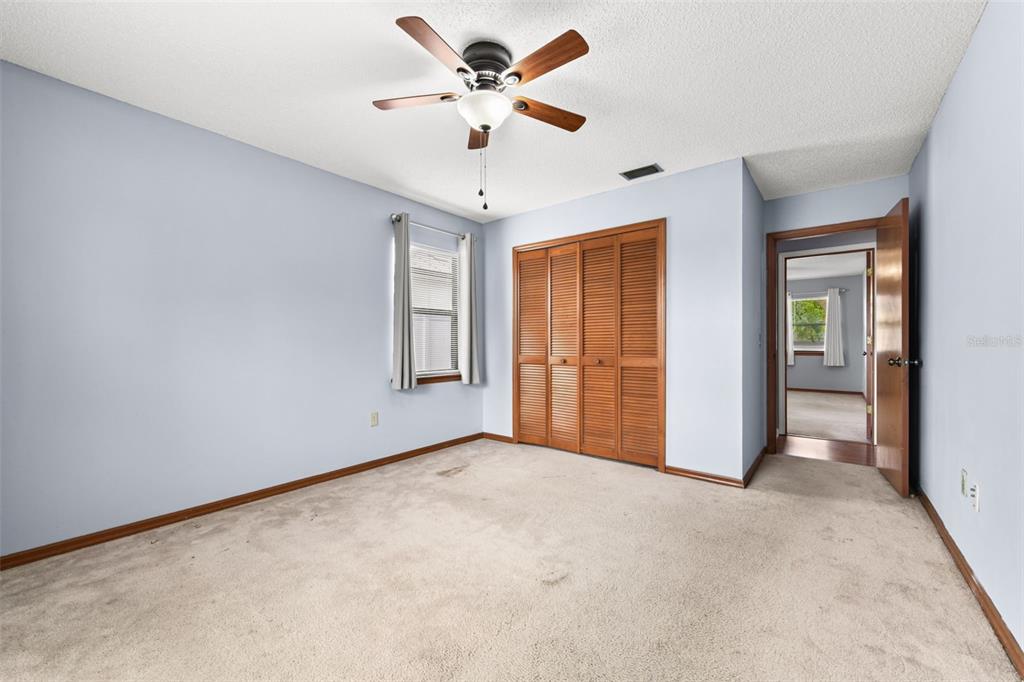 1580 East Normandy Boulevard Deltona, FL 32725 - Photo 25 of 46 an empty room with chandelier fan and windows
