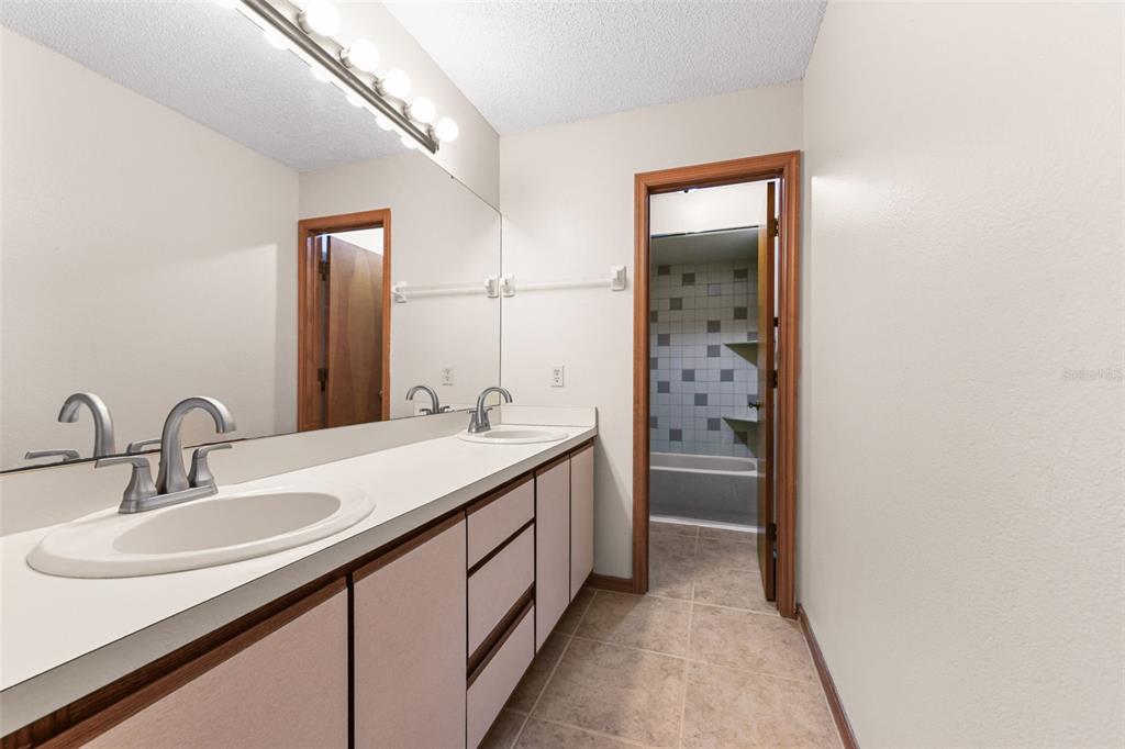 1580 East Normandy Boulevard Deltona, FL 32725 - Photo 26 of 46 a bathroom with a sink and a mirror