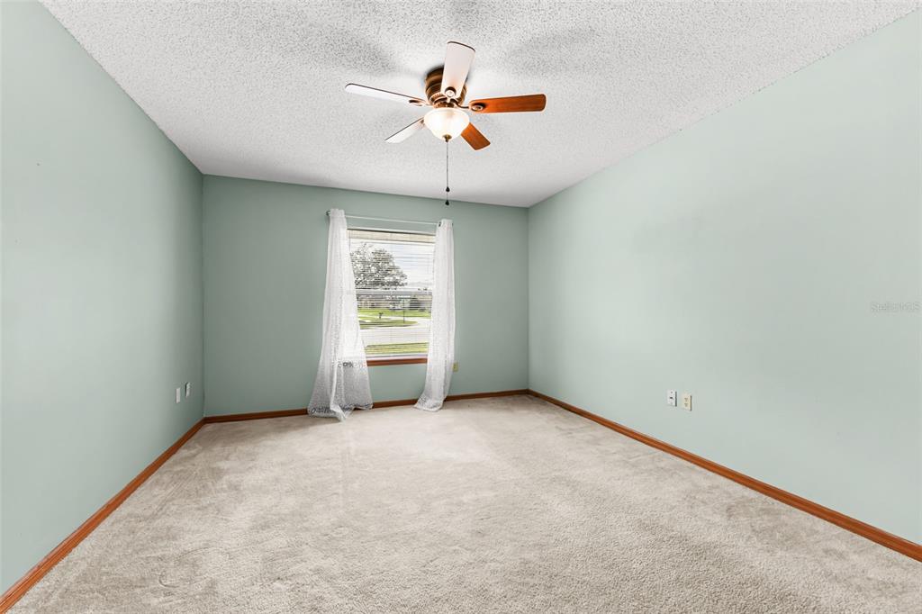 1580 East Normandy Boulevard Deltona, FL 32725 - Photo 30 of 46 an empty room with window and ceiling fan
