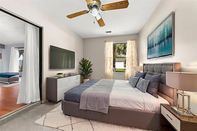 a bedroom with a bed and a flat screen tv