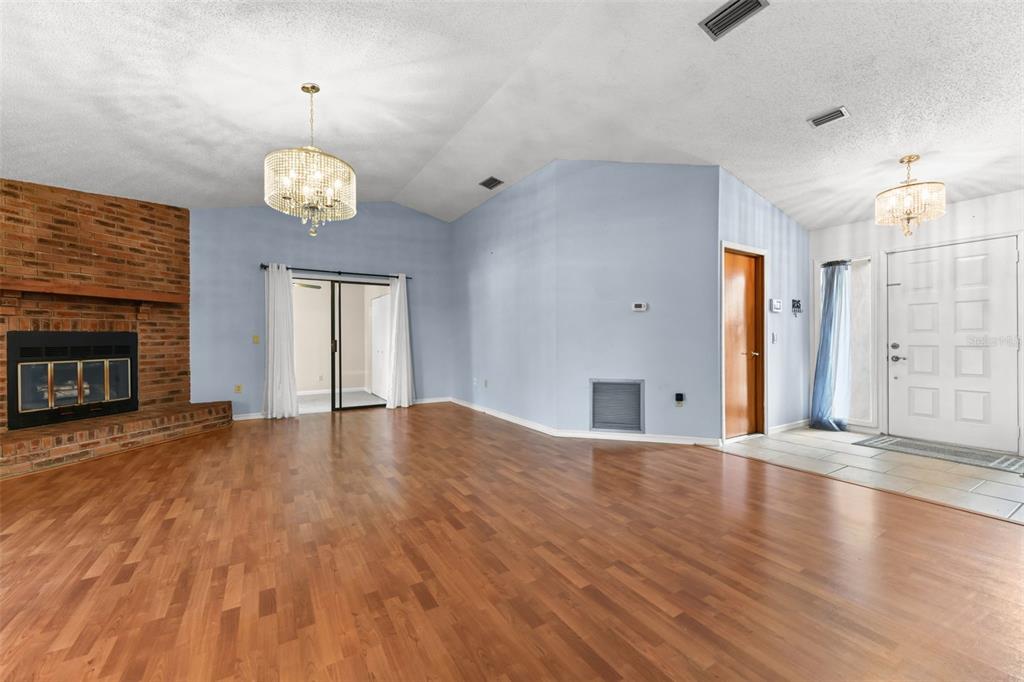 1580 East Normandy Boulevard Deltona, FL 32725 - Photo 4 of 46 a view of an empty room with a fireplace and wooden floor