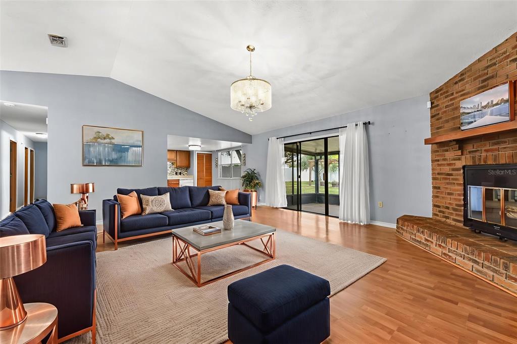 1580 East Normandy Boulevard Deltona, FL 32725 - Photo 6 of 46 a living room with fireplace furniture and a large window