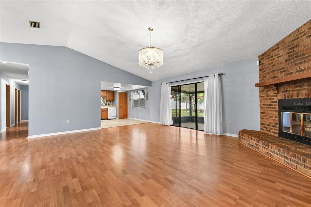 1580 East Normandy Boulevard Deltona, FL 32725 - Photo 7 of 46 a view of an empty room with wooden floor and a window
