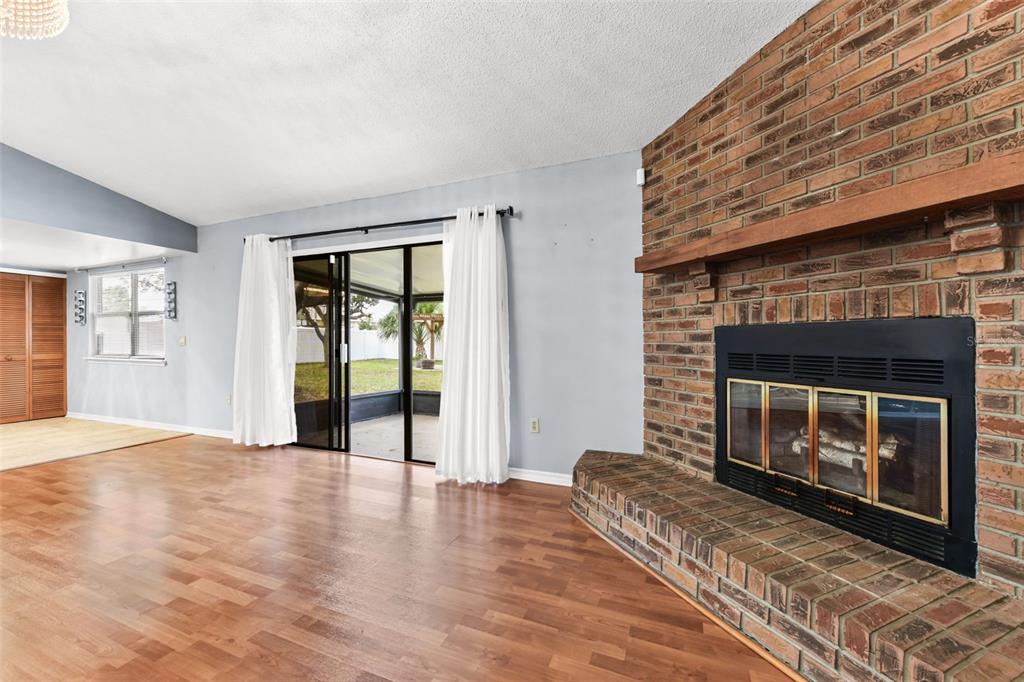 1580 East Normandy Boulevard Deltona, FL 32725 - Photo 8 of 46 a view of an empty room with wooden floor fireplace and a window