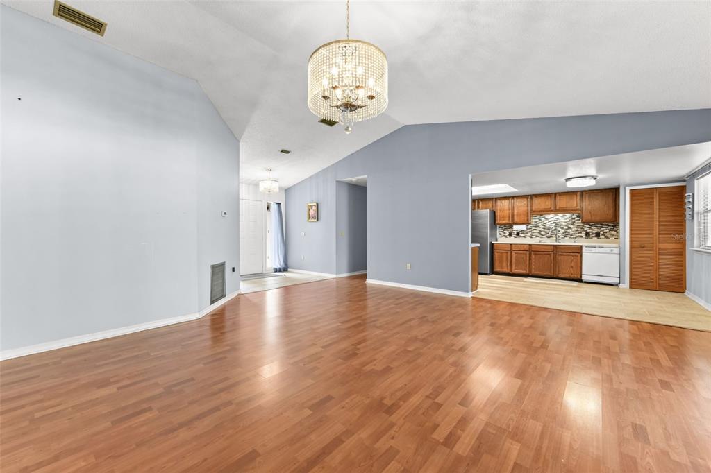 1580 East Normandy Boulevard Deltona, FL 32725 - Photo 9 of 46 a view of an empty room with wooden floor and a window