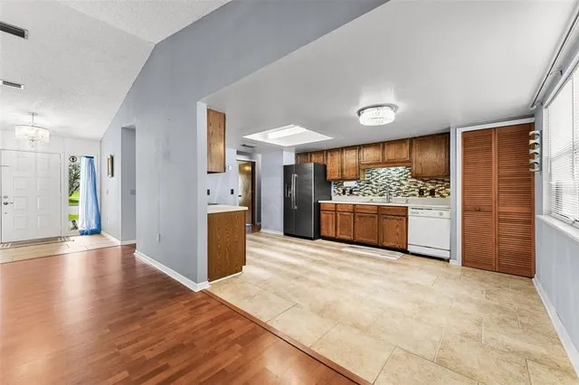 a large kitchen with a stove and a refrigerator