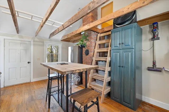 a view of a room with furniture and wooden floor