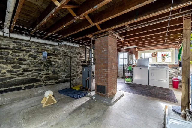 a storage room with water heater and racks